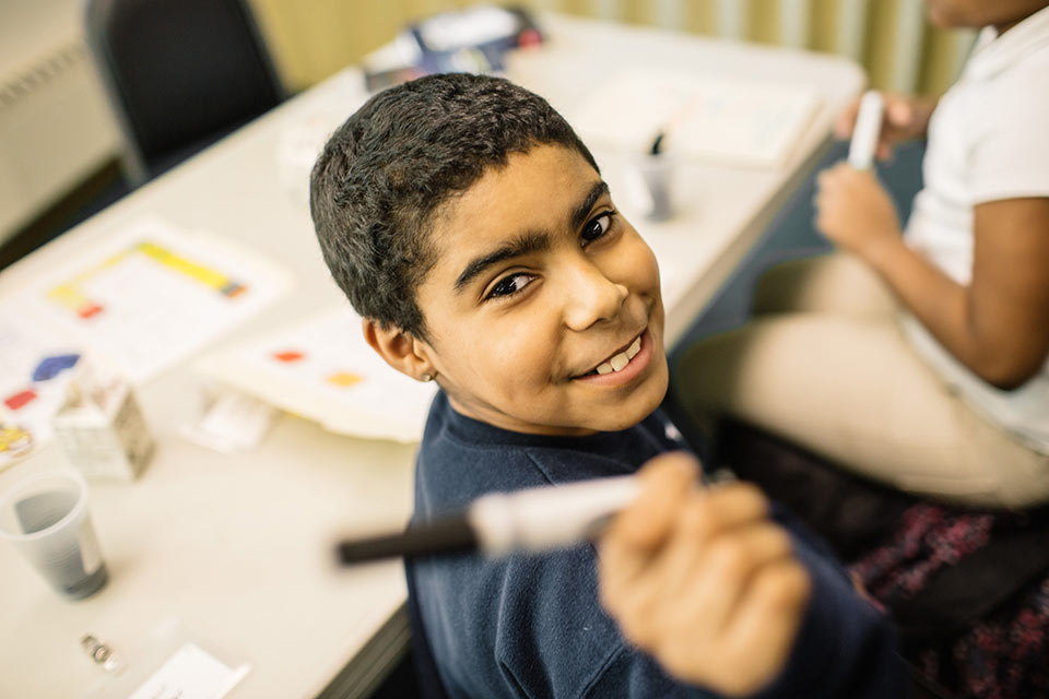 A young boy smiling at the camera