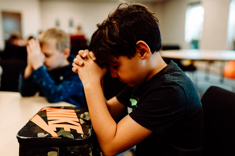 A young boy praying