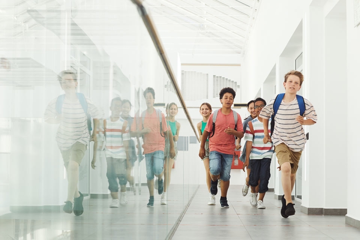 A group of kids walking through the halls of a school