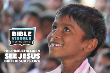 Bible Visuals International An image of a young boy smiling with the Bible Visuals International logo in the corner