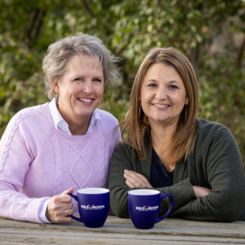 A photo of Kori Pennypacker and Lee Nienhuis sitting outside enjoying coffee