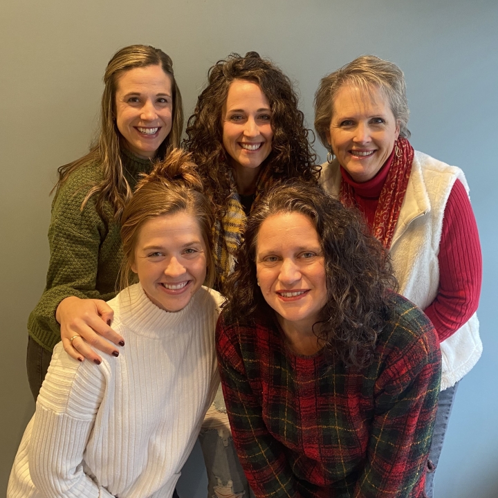 A picture of the some of the Bible2School staff smiling at the camera Megan Risser, Meredith Steidler, Kori Pennypacker (left to right, back row) and Katlin Miller and Stephanie Smith (left to right, front row)