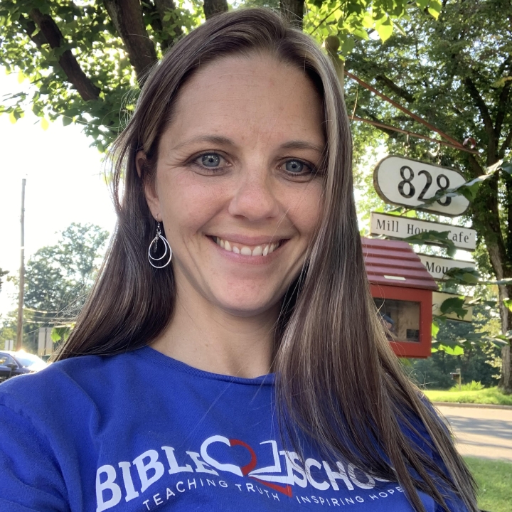 A picture of Katie Green smiling at the camera while standing outside