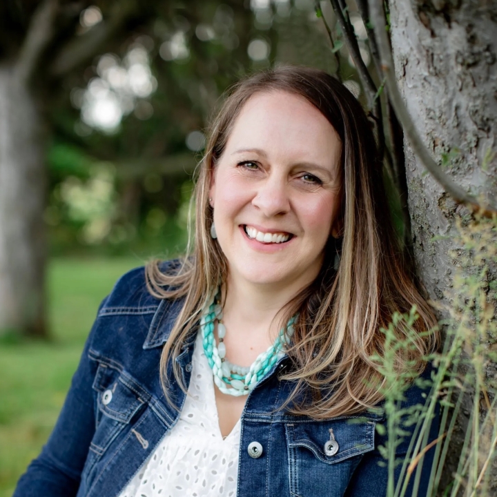 A picture of Laurie Christine sitting outside smiling at the camera