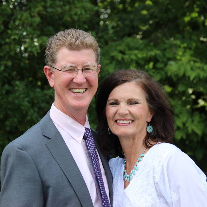 A picture of Dr. Robert and Carlotta Jackson smiling at the camera while standing together outside