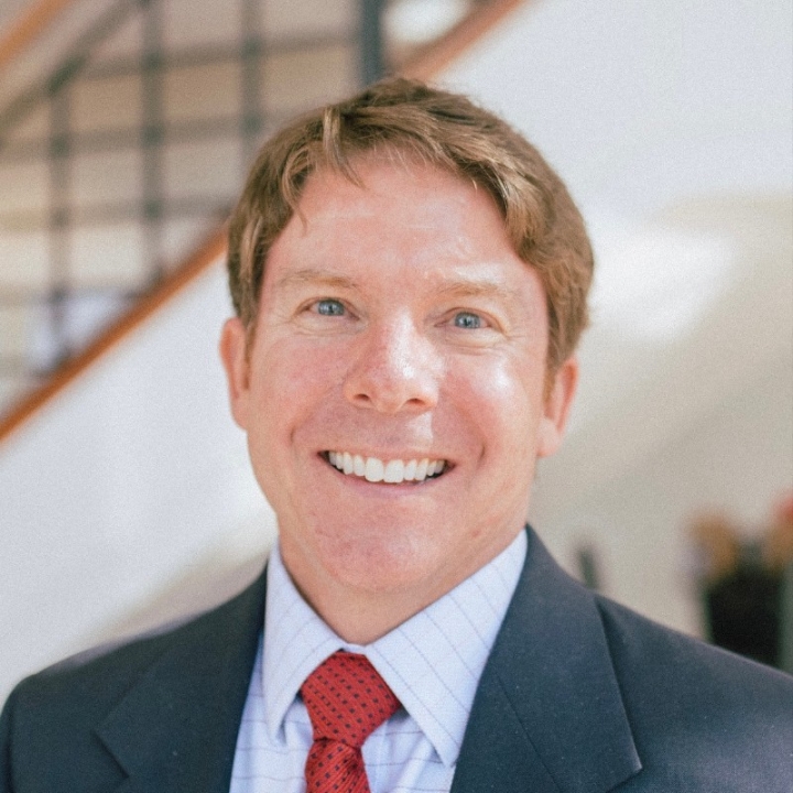 A picture of Dr. Adam Rasmussen smiling at the camera
