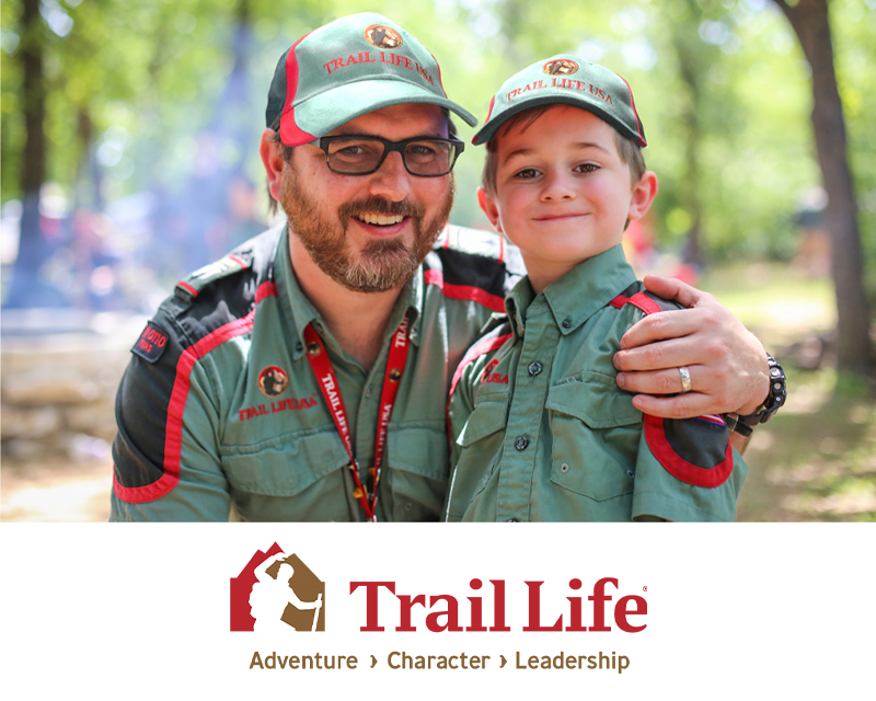 A man and a boy smiling at camera in their Trail Life USA uniforms