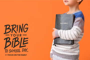 A boy holding a Bible